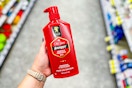 person holding a bottle of old spice shampoo in an aisle