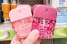 hand holding two smart care hand sanitizer sprays at dollar general