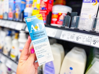 hand holding a+d hydrogel spray in walmart aisle
