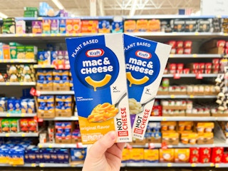 hand holding two boxes of kraft not mac and cheese in walmart aisle