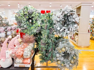 a display of christmas wreaths and garlands