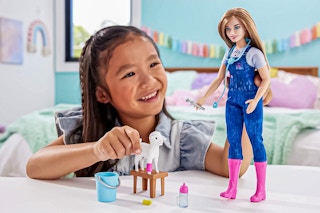 Lifestyle image of the Barbie 65th Anniversary Careers Farm Vet Doll being played with by a child