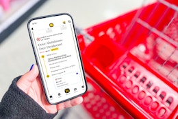 hand holding smartphone with kcl app and showing 1-clip deal next to red shopping cart