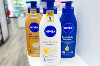 three bottles of nivea skin firming lotion on counter