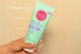 hand holding shaving cream in shower