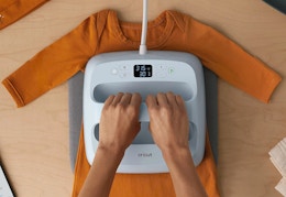 Some using a Cricut Bluetooth heat press on a shirt. 