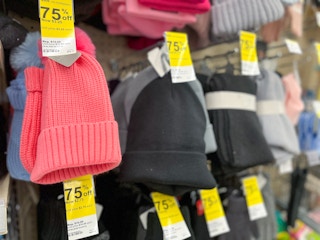 winter beanies on a shelf with 75% off clearance tags