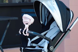 portable fan clipped onto a stroller