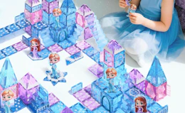 a little girl playing with a blue and purple castle building set 