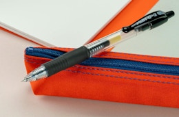 a black gel pen on a red pouch
