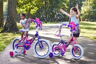 two girls playing with bikes