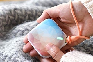 A hand holding a hand warmer