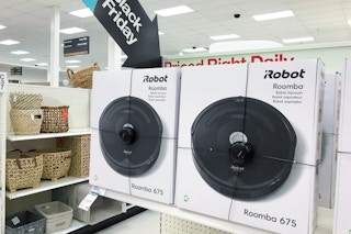 Amazon iRobot Roombas on a shelf with a big sign shaped like an arrow that says, "Black Friday" pointing to the Roombas.
