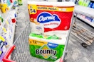 large packs of charmin and bounty paper products in a cart