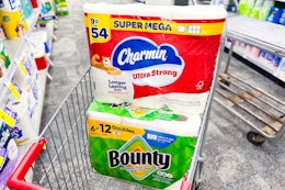 large packs of charmin and bounty paper products in a cart