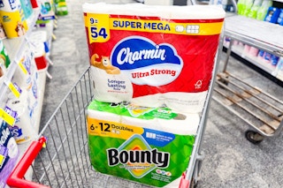 large packs of charmin and bounty paper products in a cart
