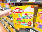 hand holding playdoh blooming flowers playset on walmart shelf