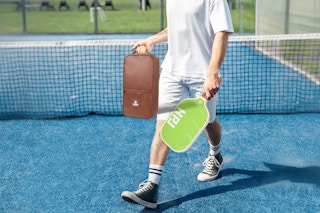 Man walking with his pickleball set
