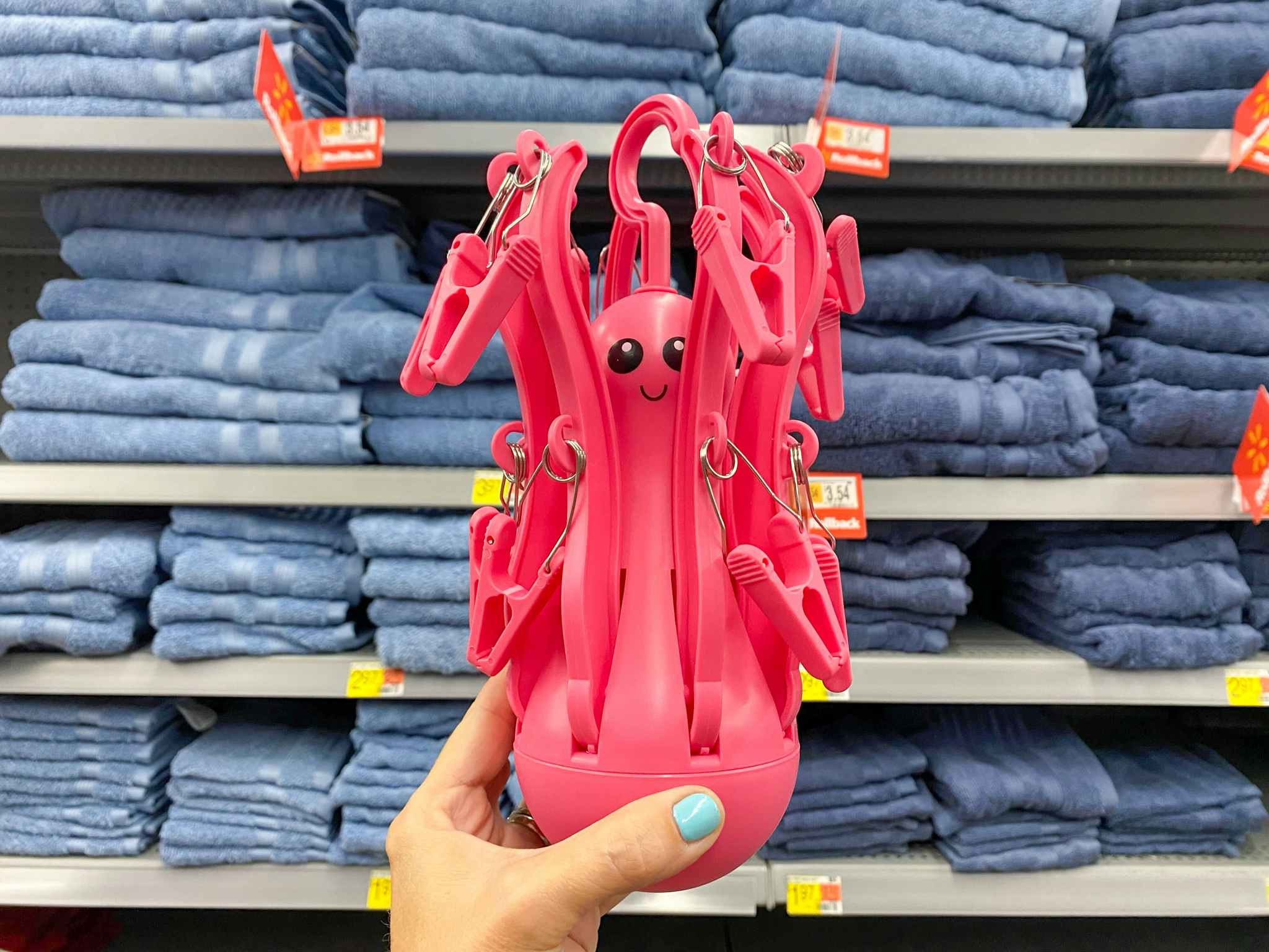 hand holding folded octopus drying hanger at walmart
