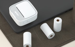 a sticker printer and rolls of paper 