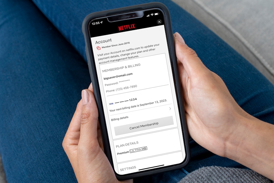 woman holding iPhone canceling Netflix membership