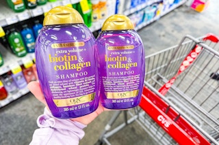 hand holding two ogx shampoos at cvs