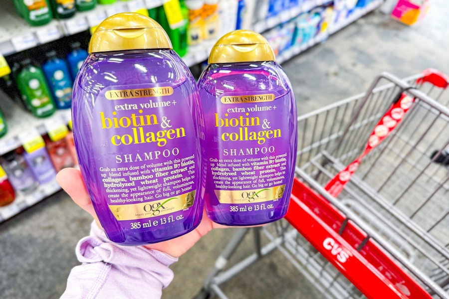 hand holding two ogx shampoos at cvs
