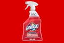a spray bottle of carpet cleaner on a red background