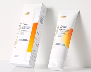 a tube of body cream next to its packaging 
