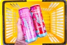 hand holding alani nu energy drinks above a yellow basket