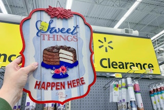the pioneer woman sweet things sign held up in front of walmart clearance signs