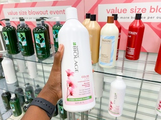 hand holding jumbo shampoo bottle