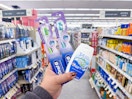 hand holding crest and oral-b items in walgreens