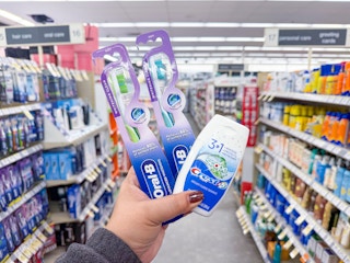 hand holding crest and oral-b items in walgreens