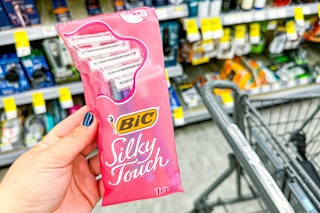hand holding a pack of bic silky touch razors