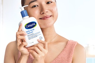 someone holding a bottle of cetaphil face wash