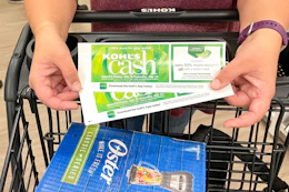 a woman holding kohls cash pushing a cart