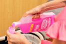 a woman pouring the pink stuff floor cleaner