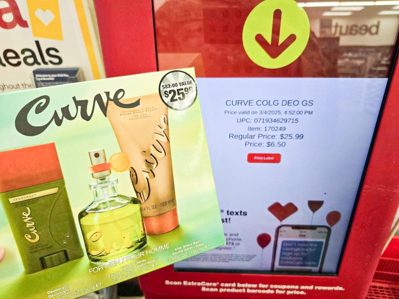 person scanning a curve fragrance gift set on a cvs price kiosk for $6.50