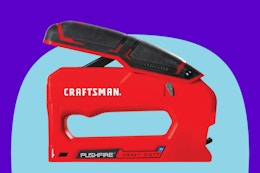 a red stapler next to an Amazon box