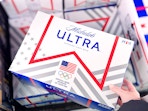 hand holding a case of michelob ultra beer