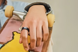 Lifestyle image of a close up shot of a hand over a skatboard with the Samsung Galaxy Ring on pointer finger