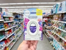 hand holding febreze bathroom air freshener in walgreens