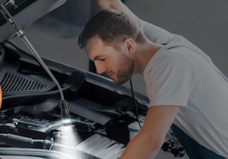 a person fixing a car with a magnetic pickup tool
