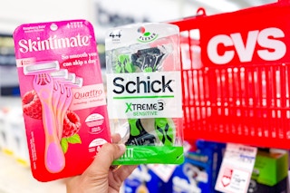 hand holding skintimate and schick disposable razors next to a cvs shopping basket