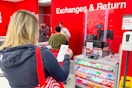 someone waiting in line for the customer service desk at Target to get a price match adjustment