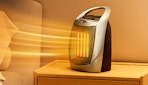 a small heater on a nightstand