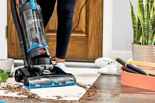 Bissell PowerForce Helix being used to clean up dirt off the floor