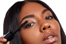 a woman using rimmel mascara