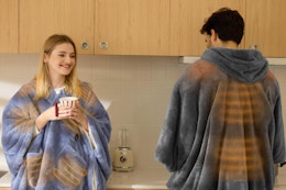 Man and woman wearing the Bedsure Cordless Heated Blanket.
